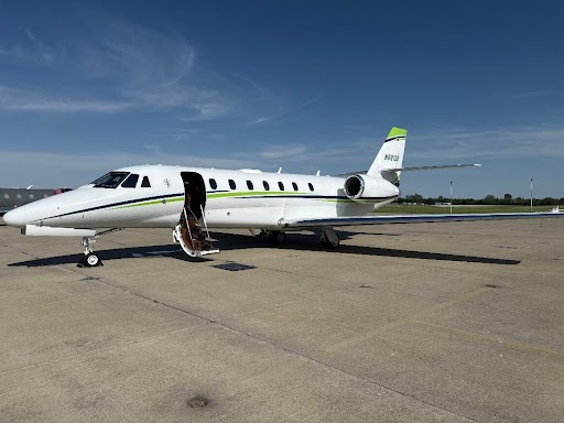 Private jet on airport runway.