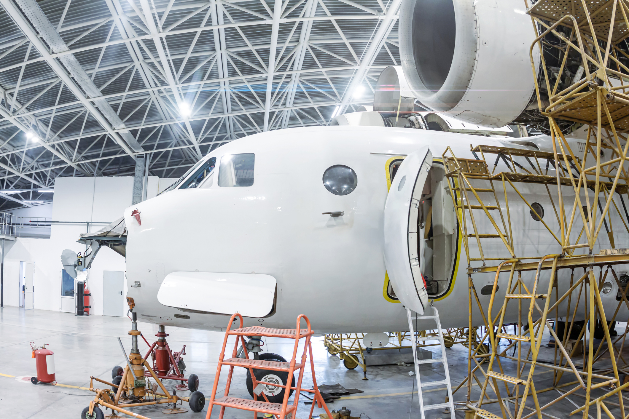 Airplane under maintenance in a hangar.